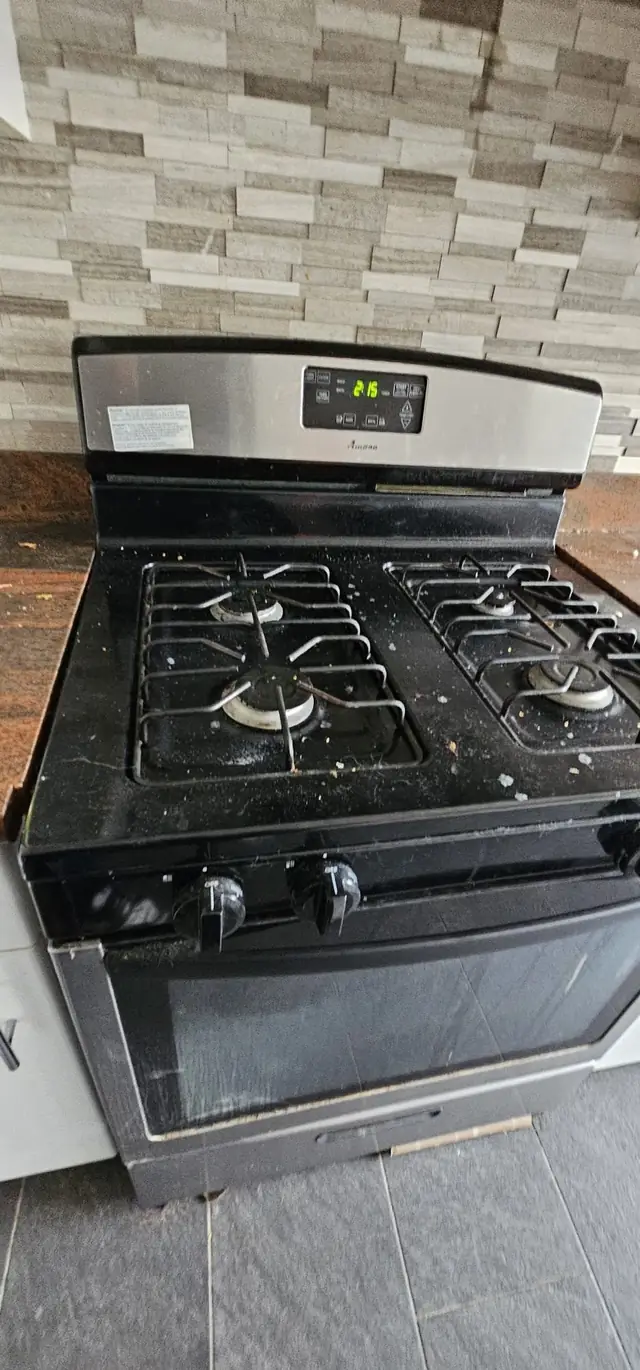 A stainless gas range cleaned for a move-out, grates and burners bright
